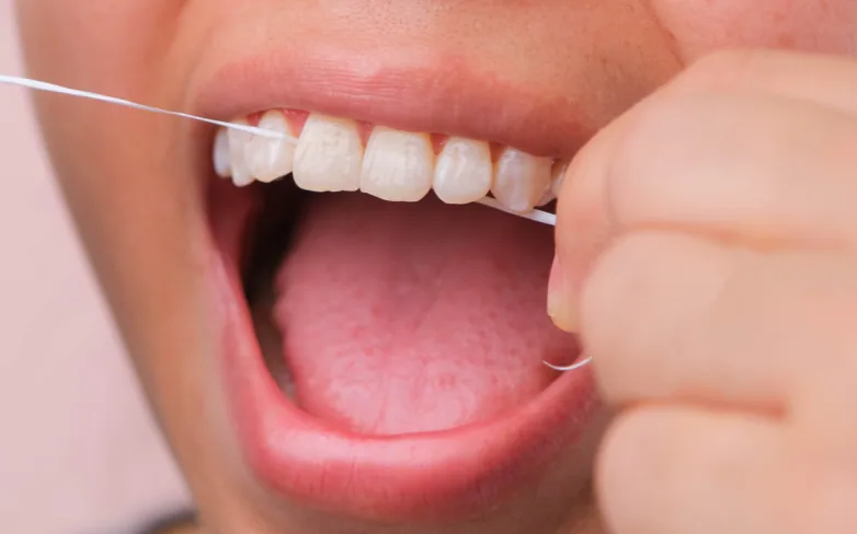 Close-up of teeth being flossed